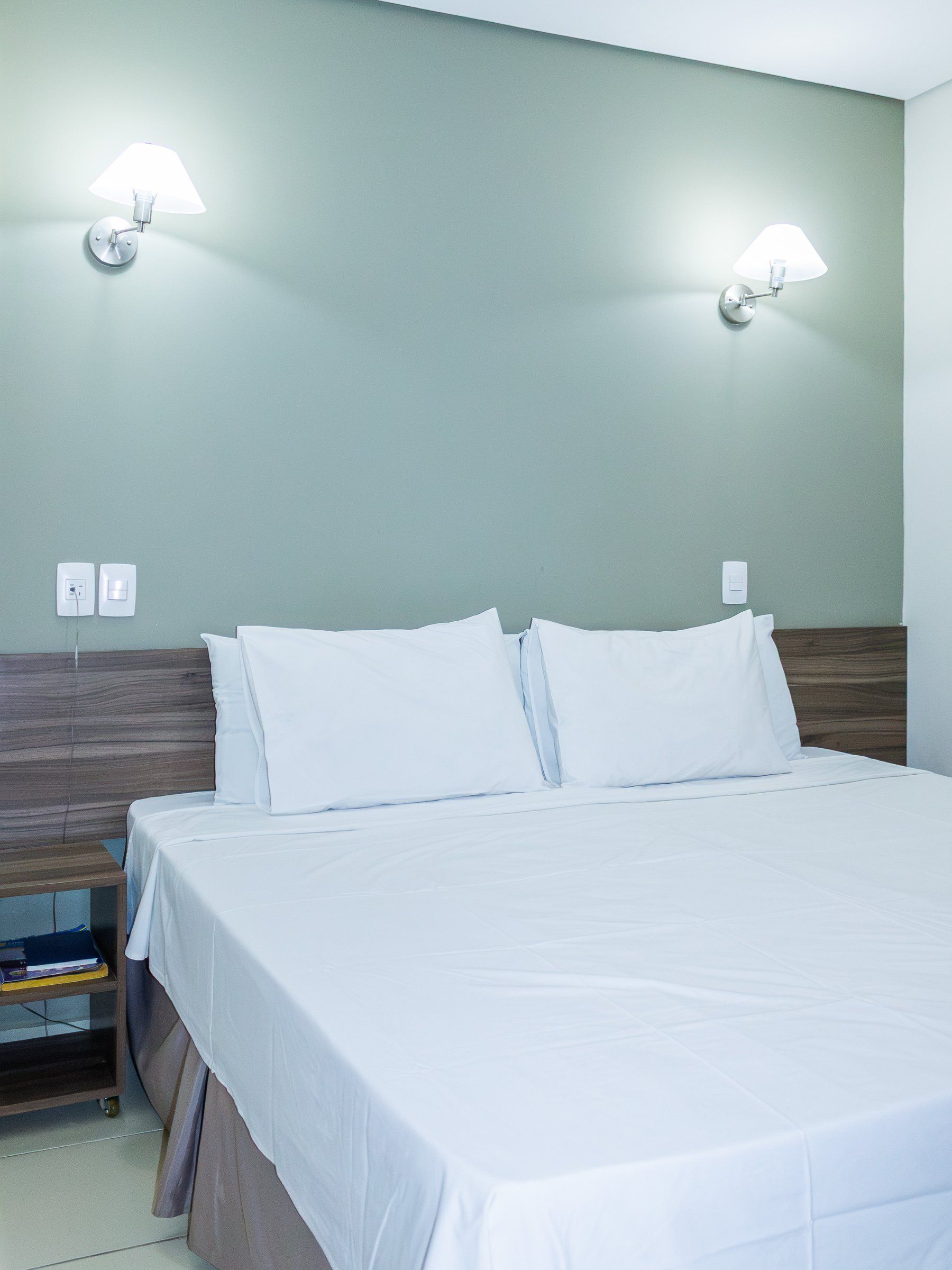 Deluxe Double room, wooden headboard and bedside table
